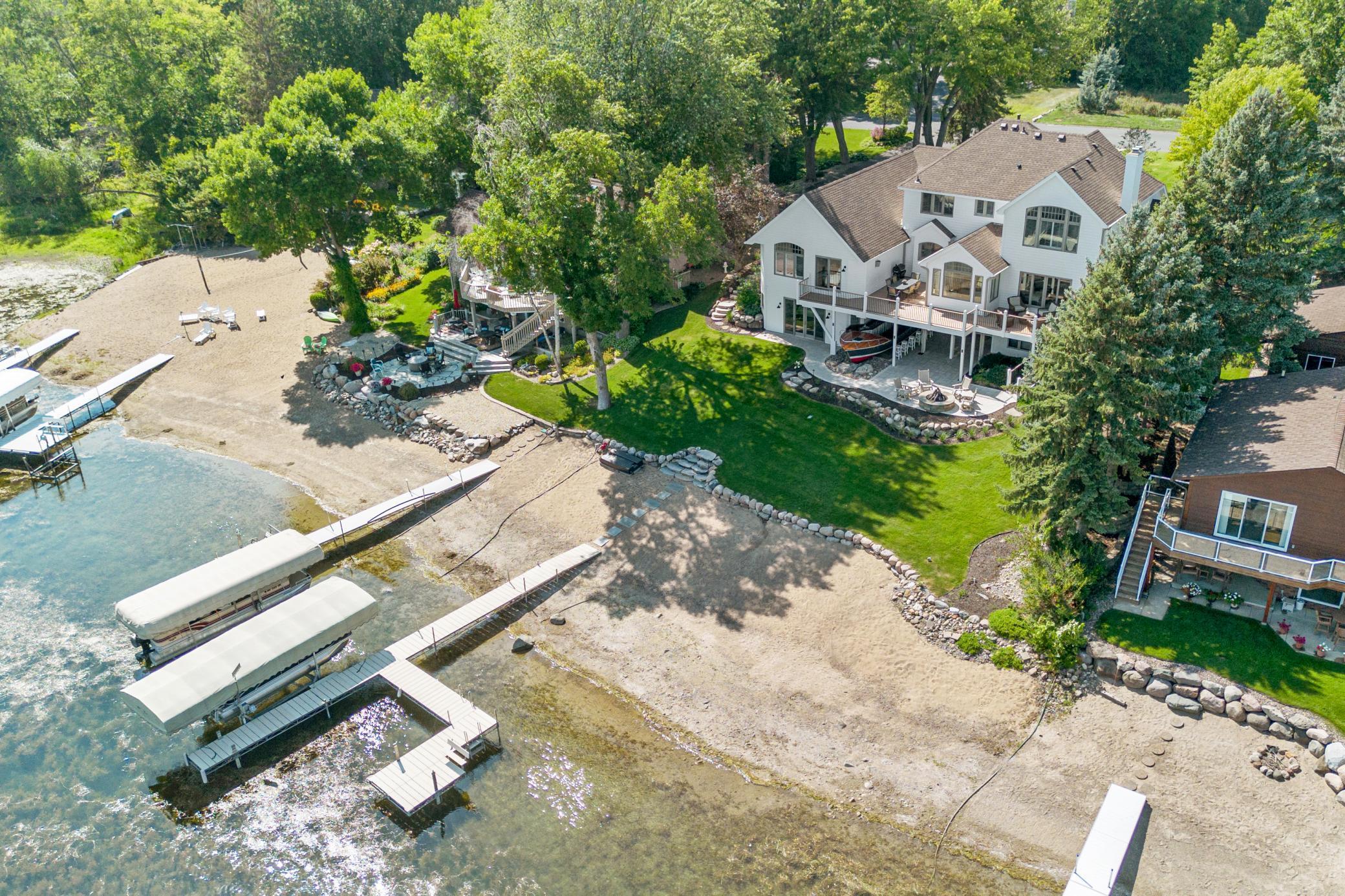 Enjoy lakeside living with a sandy shoreline, plus a dock and lift included with the property.