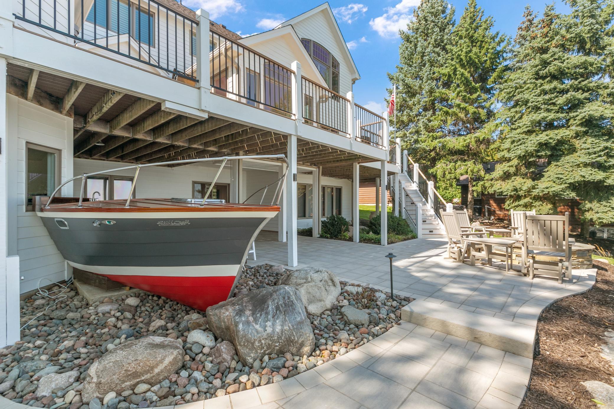 From the shoreline, the lower deck and custom boat bar create a fun and memorable gathering spot right by the water.