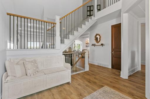 Beautiful open entry space showcasing soaring ceilings and a stunning staircase that makes a lasting first impression.