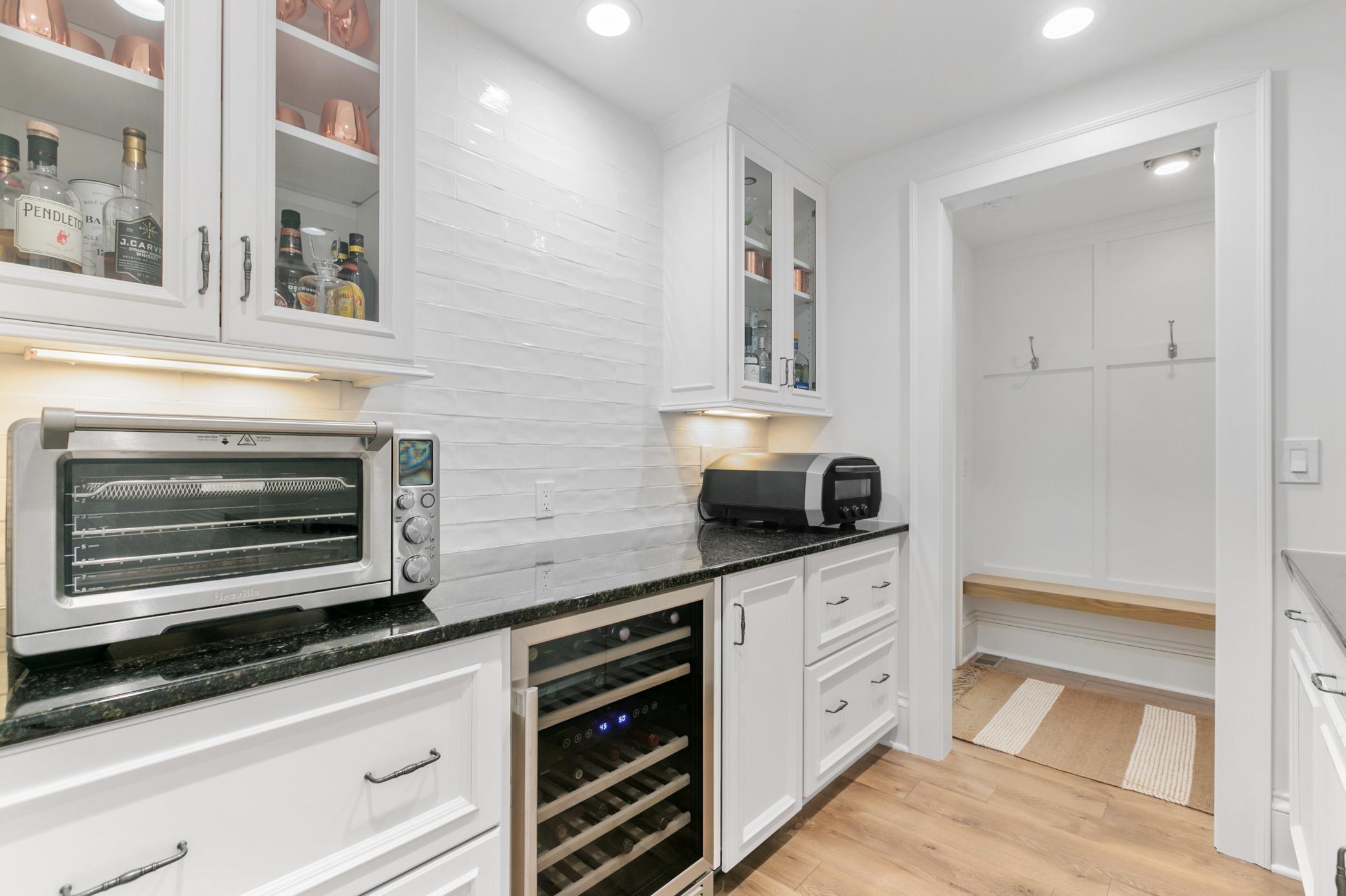 Stylish backsplash and accent lighting make this space functional and pretty!