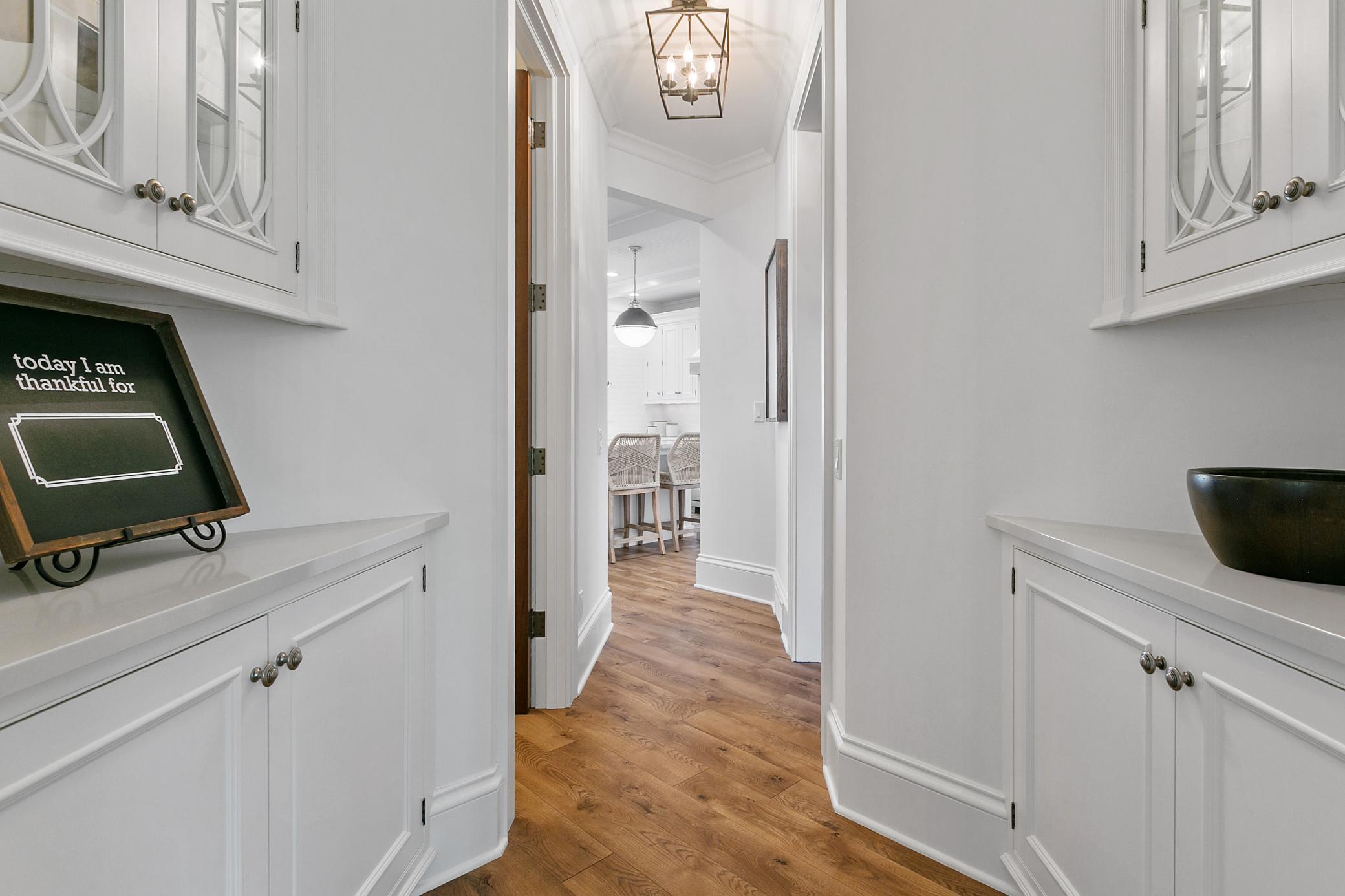 Between the formal dining room and kitchen is a charming butlers space with cabinets and counters for ease of entertaining.