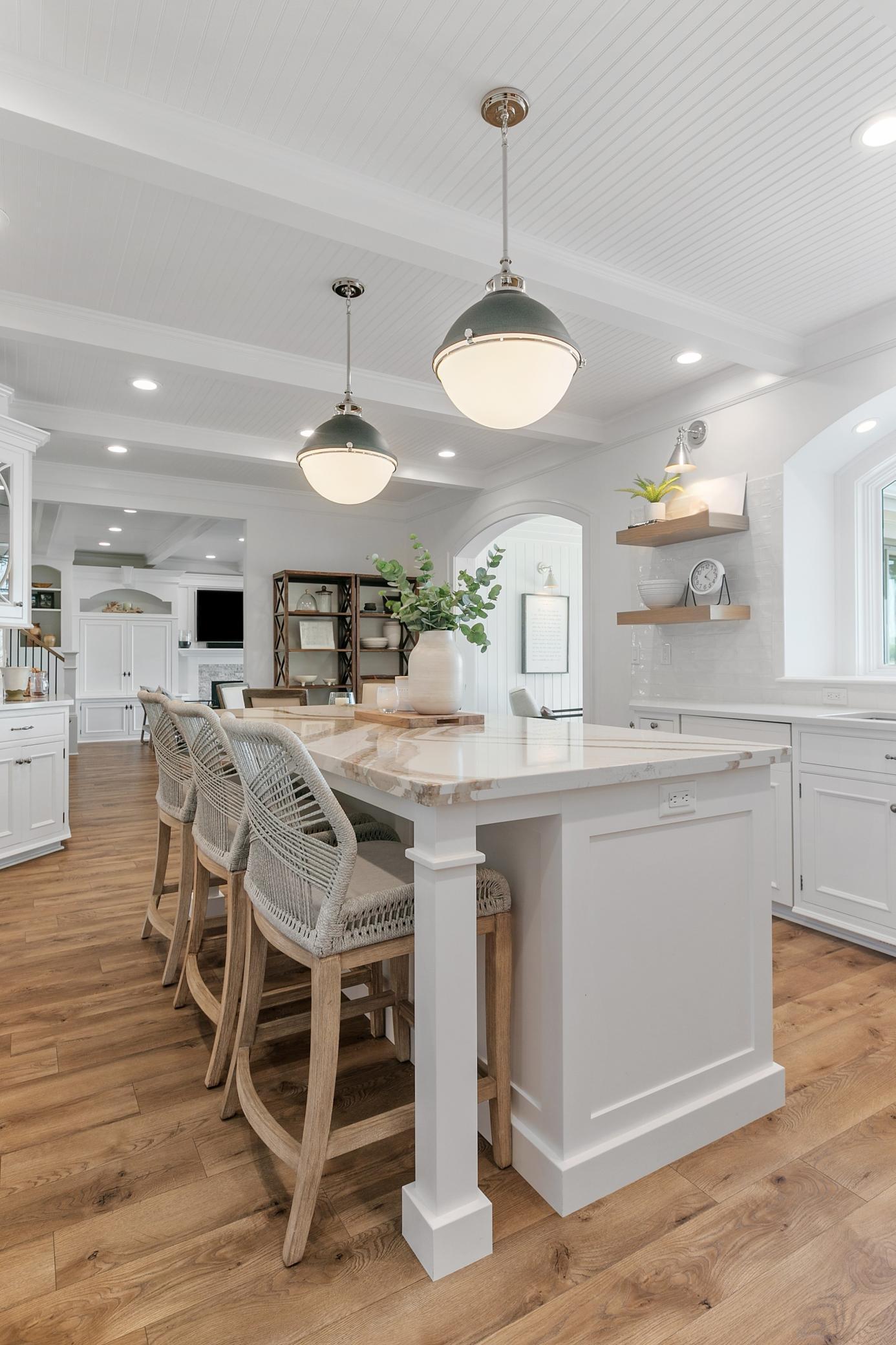 Spacious and well-equipped kitchen with a beautiful island for seating and stunning lake views just beyond the windows.