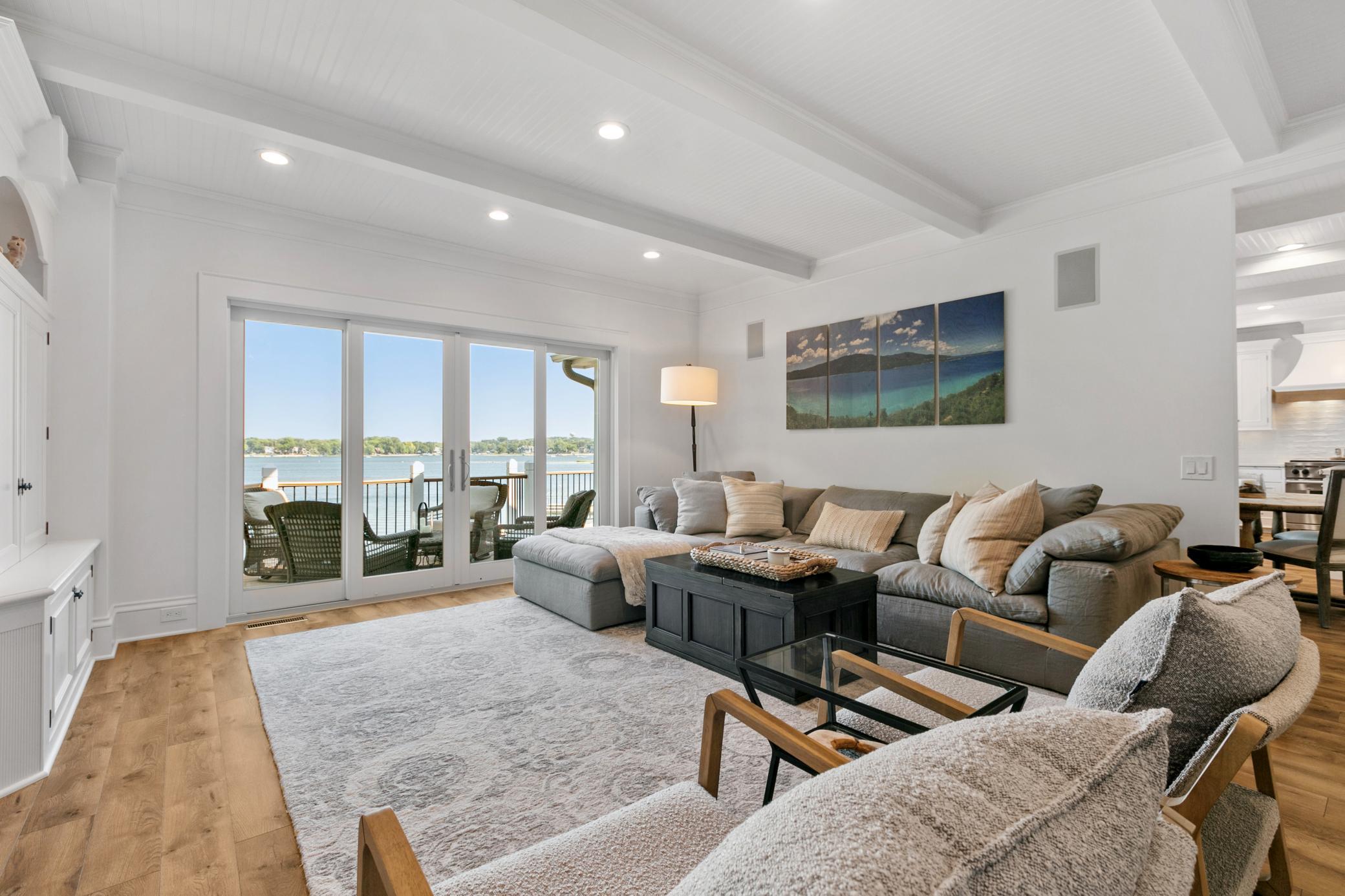 Warm and inviting main level living room with a large patio door that opens wide to connect indoor living with the outdoors.