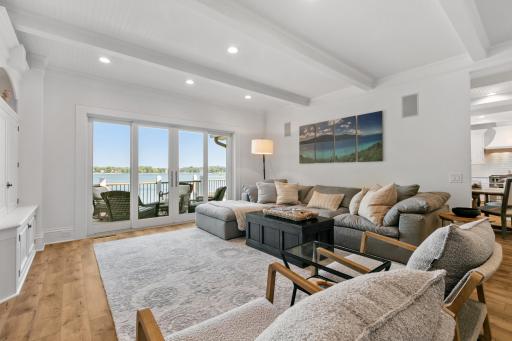 Warm and inviting main level living room with a large patio door that opens wide to connect indoor living with the outdoors.