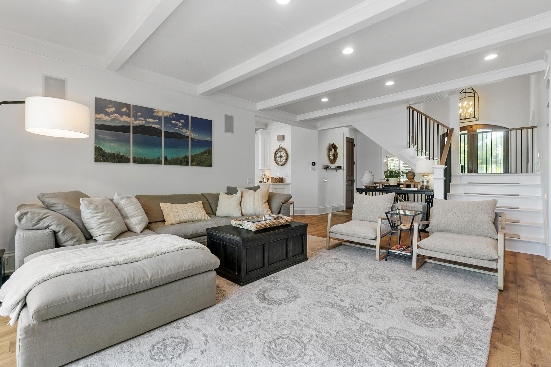 Comfortable main level living room where the wide patio door opens to create a seamless flow to the outdoor living space.