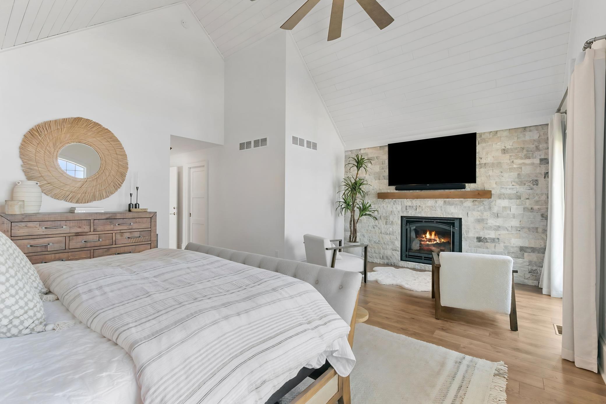 A cozy fireplace creates the perfect atmosphere for relaxing in the primary bedroom.