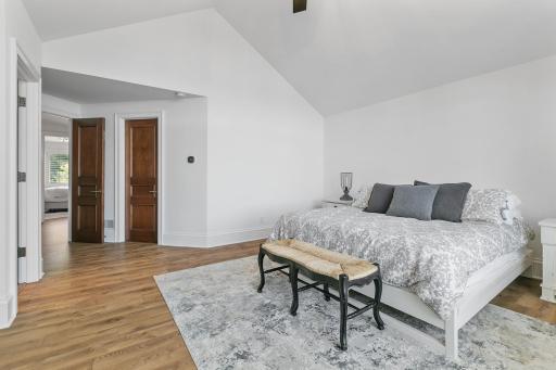 The upper level primary bedroom has a large walk in closet, huge window and vaulted ceiling.
