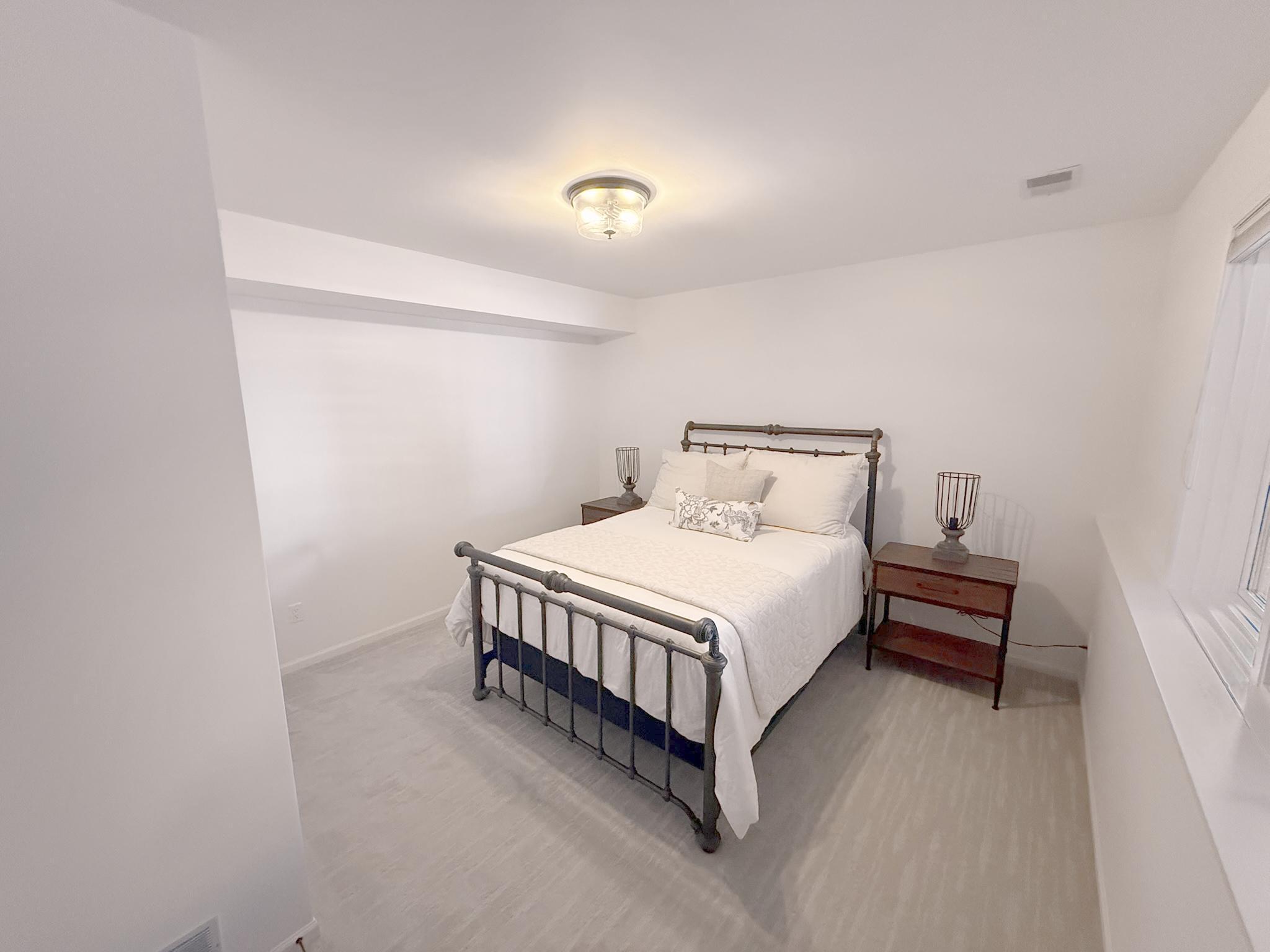 Cozy lower-level bedroom with generous closet space, ideal for guests or a flexible hobby room.