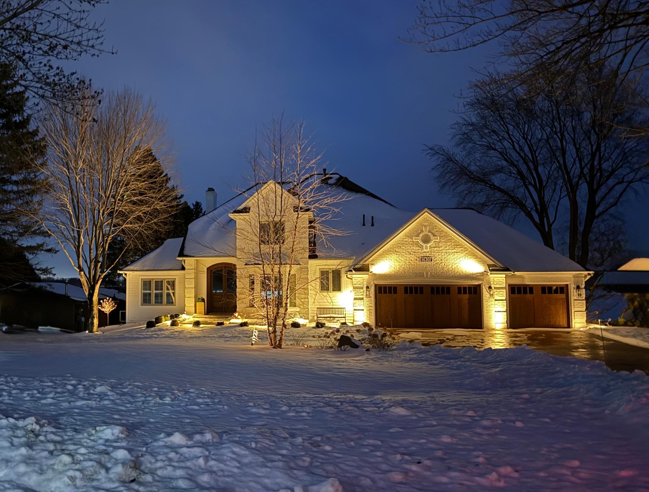 Beautiful accent lighting on the landscaping and exterior makes this home breathtaking in all four seasons - even when it's dark and snowy at 5pm!