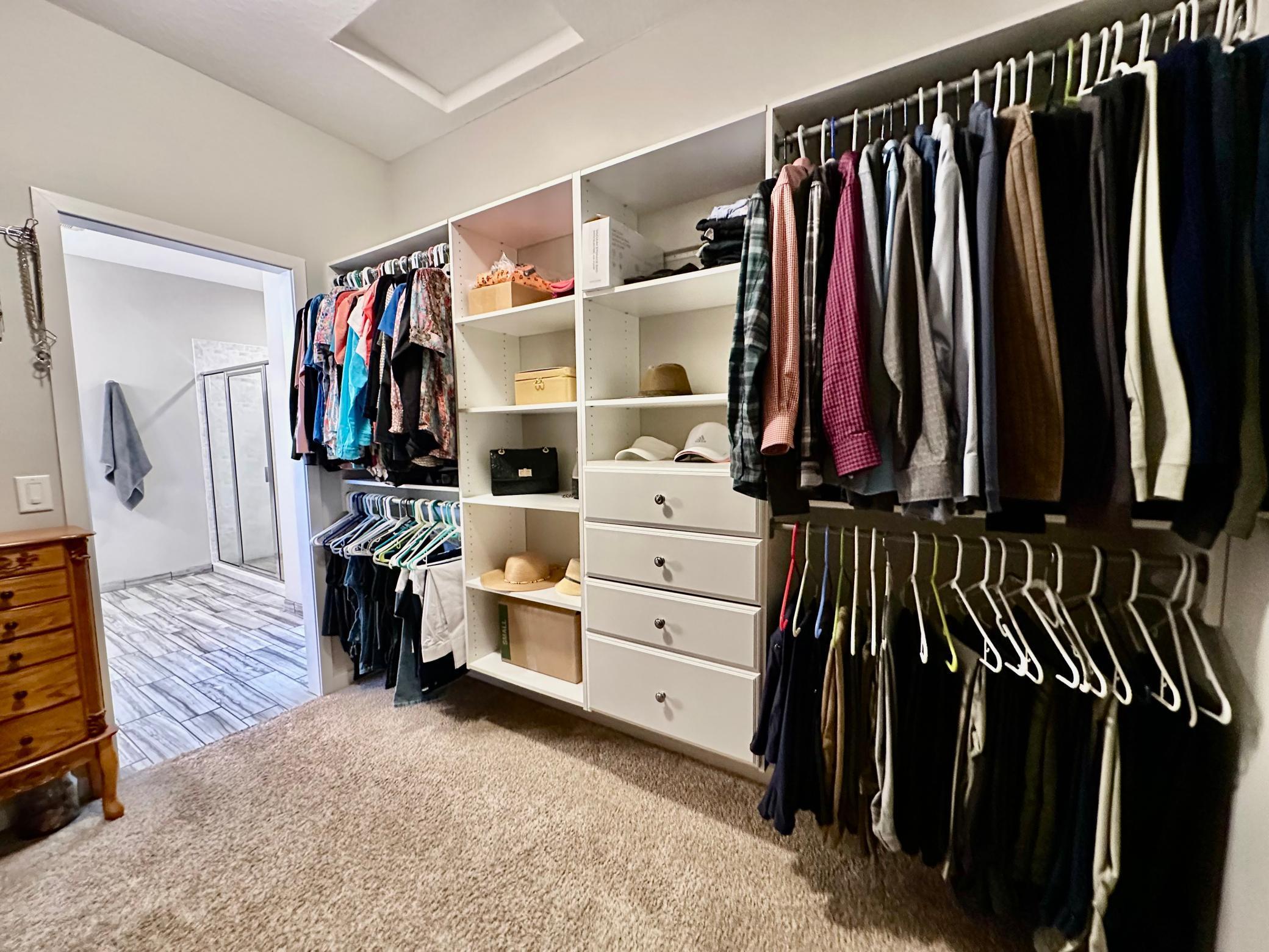 Built-in closet organizer in walk-in closet