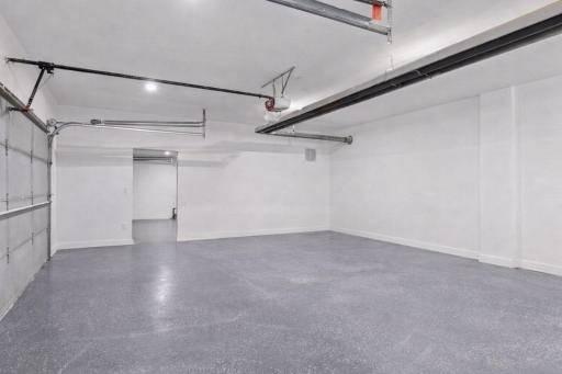A finished six-car heated Garage offers incredible space for vehicles, hobbies, and storage, with durable epoxy flooring throughout.