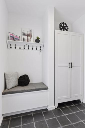 A built-in bench and generous cabinetry bring both function and style to the Mud Room, creating a well-organized space for everyday living.