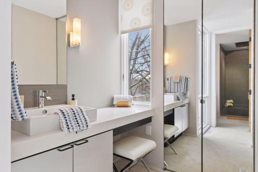 The Primary Bathroom features separate vanities, with a mirrored linen closet adding a polished finishing touch.