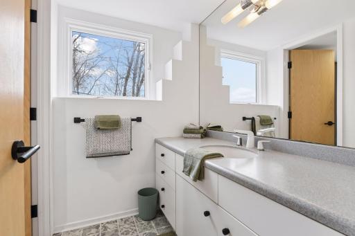 The Full Bathroom features designer LVP flooring and updated hardware, bringing a fresh, contemporary feel to the space.