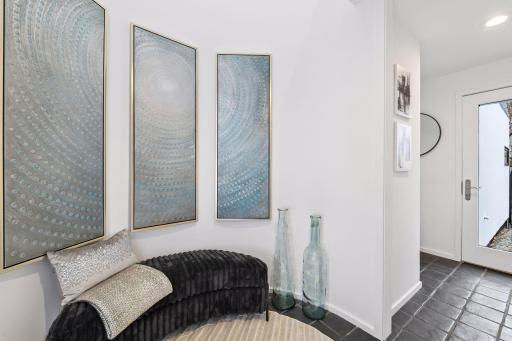 Distinctive detail meets everyday function in the Mud Room, featuring a graceful curved wall and direct access to the fenced-in side yard.
