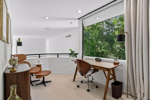 The Primary Suite spans the upper level, with a versatile loft that offers an inspiring setting for a home office, reading nook, or quiet retreat.