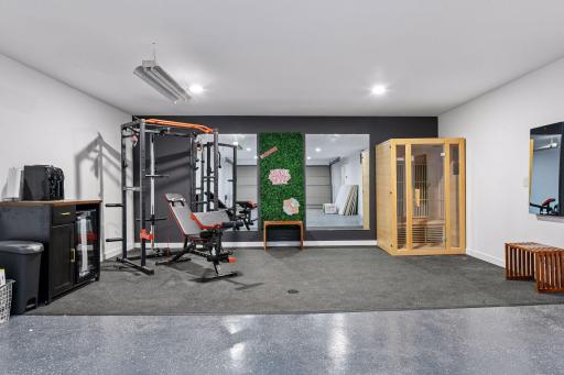 A dedicated Exercise Room brings a private wellness experience home, complete with a mirrored wall, Echelon Reflect Interactive Fitness Mirror, and infrared sauna with red-light chromotherapy.