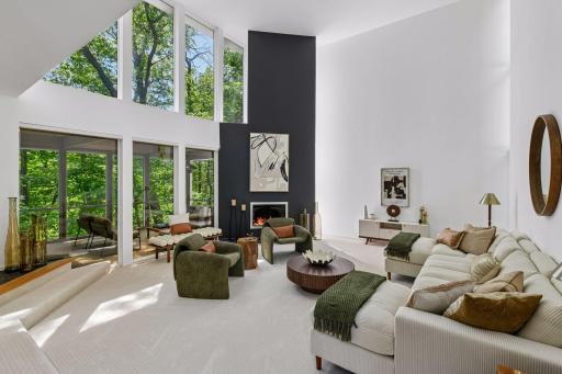 Architectural volume takes center stage in the Great Room, where soaring ceilings, abundant natural light, and a gas fireplace create a striking space for entertaining.