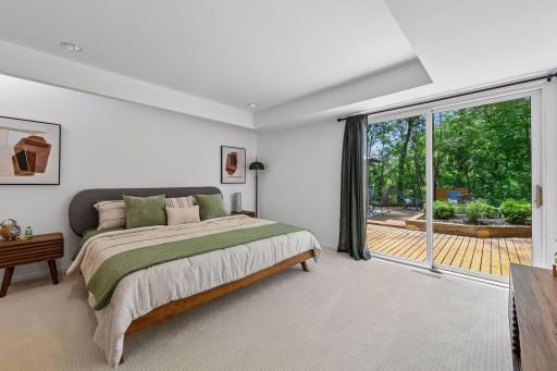 The second lower-level Bedroom offers generous space and direct access to the side deck, creating a comfortable connection to the outdoors.
