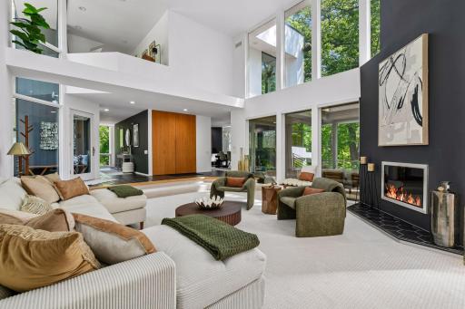 Walls of glass throughout the home draw the incredible natural setting indoors, filling the contemporary spaces with light and ever-changing views.