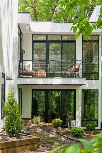 A striking composition of bold black-framed windows, clean lines, and varied rooflines gives the exterior its distinctive contemporary character.