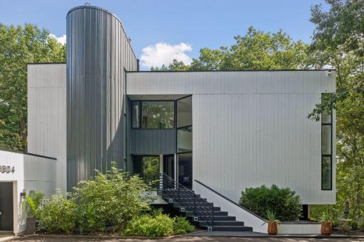 A refreshed exterior makes a striking first impression, featuring new siding, a new driveway, and new railings.