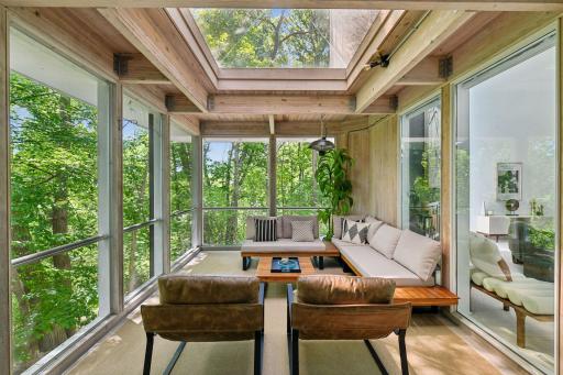 Treetop views, a maintenance-free decking, and an overhead skylight come together in this peaceful screen porch—a private setting to relax and take in the natural surroundings.