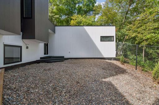 A private, fenced-in side yard adds a versatile outdoor space.