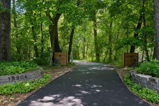 Enjoy a private 1.66-acre setting framed by towering mature trees and surrounded by the natural beauty of Minnetonka.