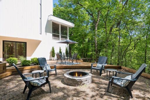 A custom campfire ring creates the perfect gathering spot for evenings under the stars.
