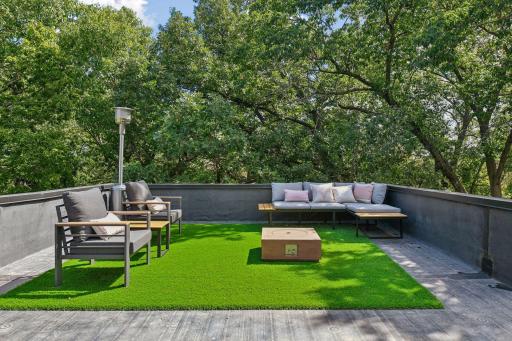 Spanning the entire rooftop, this private deck offers a peaceful perch among the treetops, surrounded by privacy and expansive views.