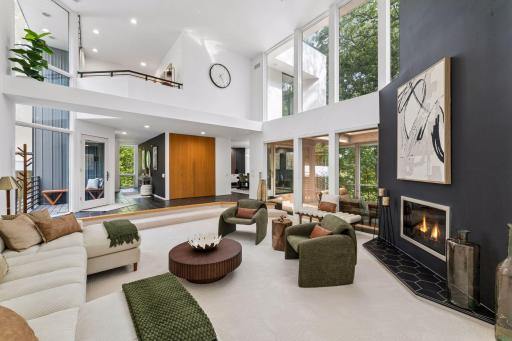 Walls of glass throughout the home draw the incredible natural setting indoors, filling the contemporary spaces with light and ever-changing views.