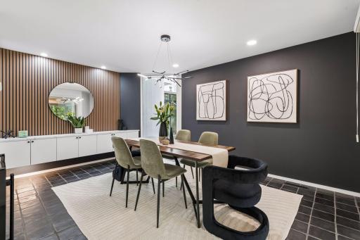 The Formal Dining Room features designer lighting, tiled flooring, and custom built-in cabinetry with a generous buffet, adding both style and function to the space.