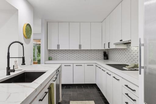 New countertop make a statement with dramatic dual waterfall edges, adding a clean finish to the Kitchen.