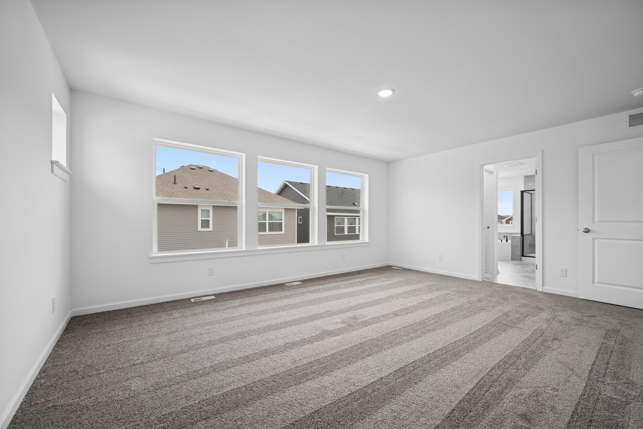 The owner's suite offers an en suite bath as well! Picture of a completed Pryor home.