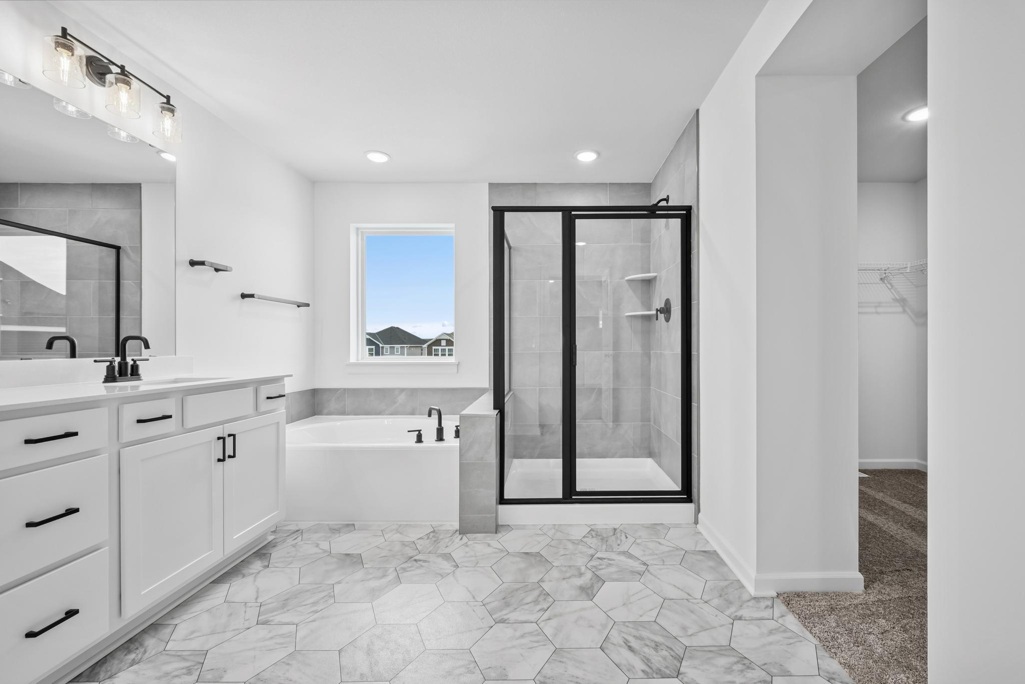 A spa bath with shower and separate tub. Picture of a completed Pryor home.
