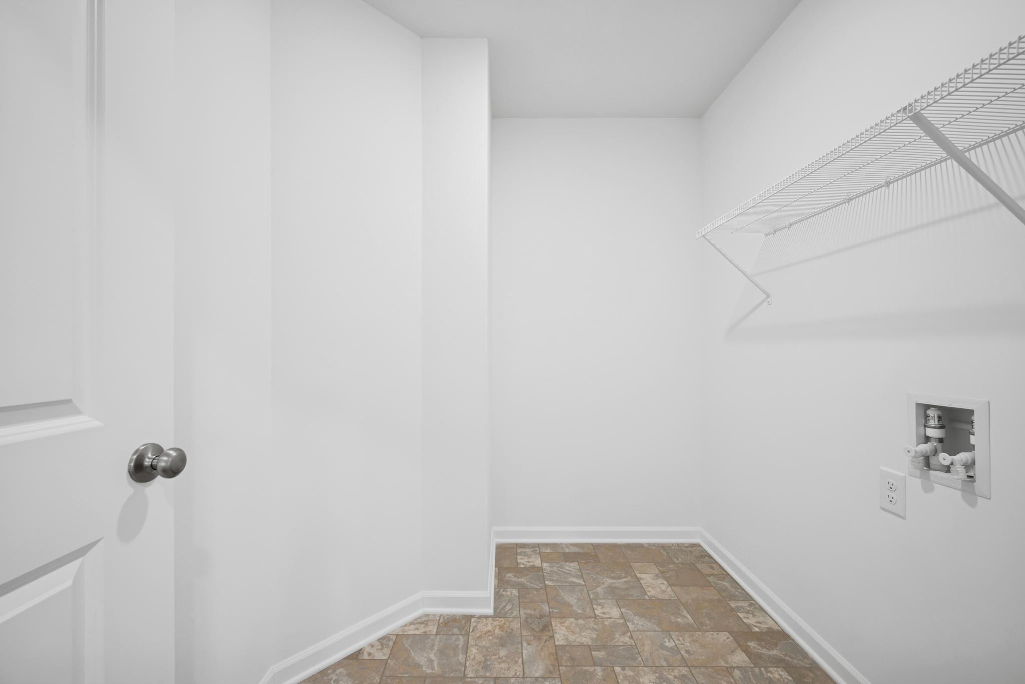 2nd floor utility / laundry room. Picture of a completed Pryor home.