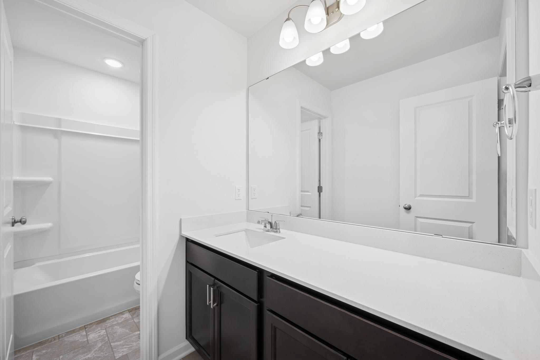 Secondary bath on the 2nd floor. Picture of a completed Pryor home.