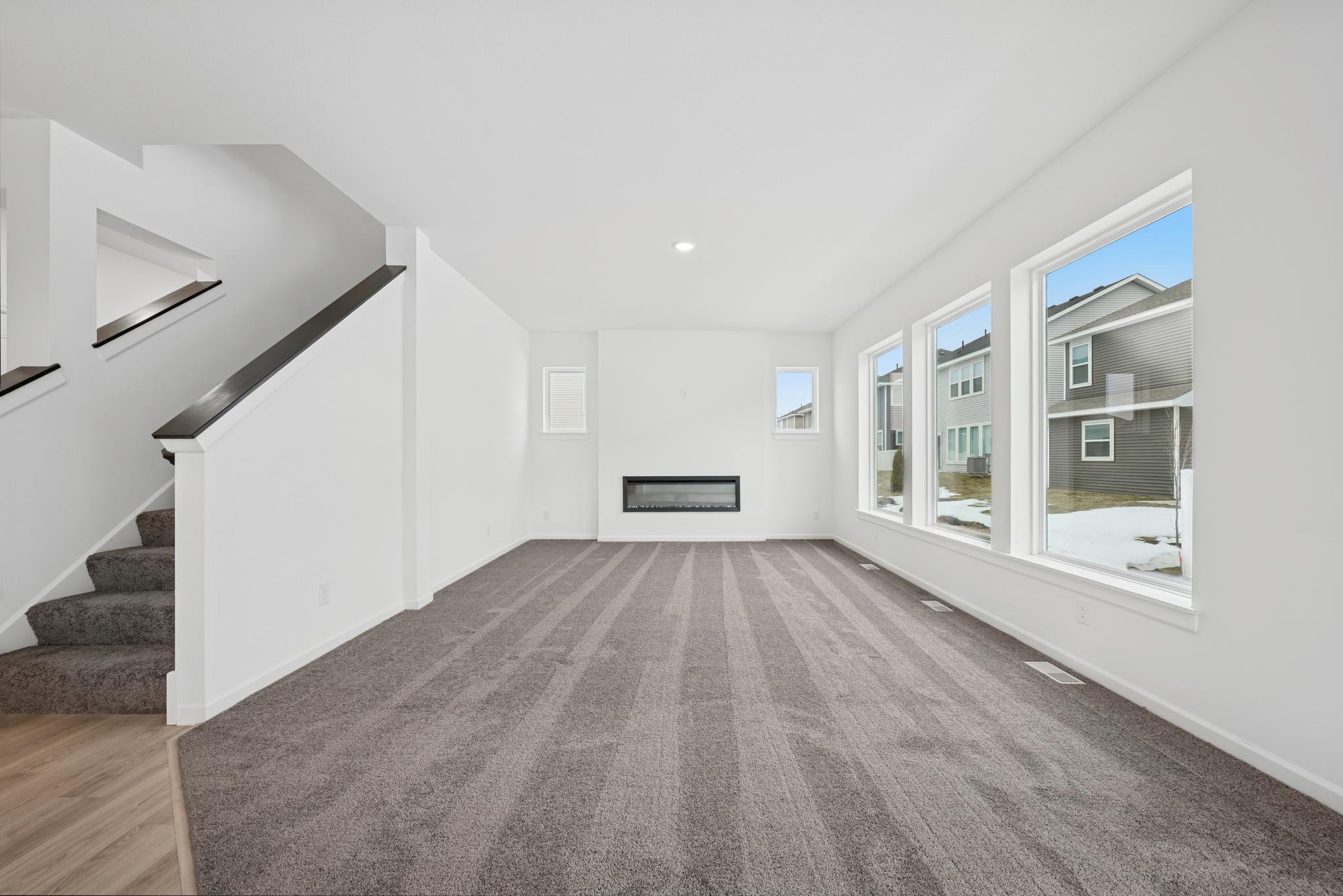 Family room with electric fireplace. Picture of a completed Pryor home.