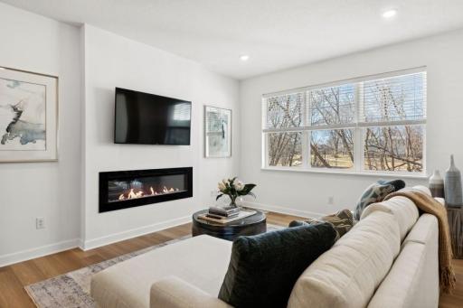 (Photo of a decorated model, actual homes finishes will vary) Relax next to the fireplace!