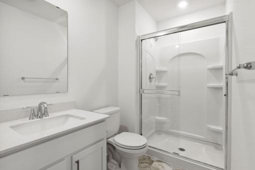 (Photo of a decorated model, actual homes finishes will vary) Lower level bath.