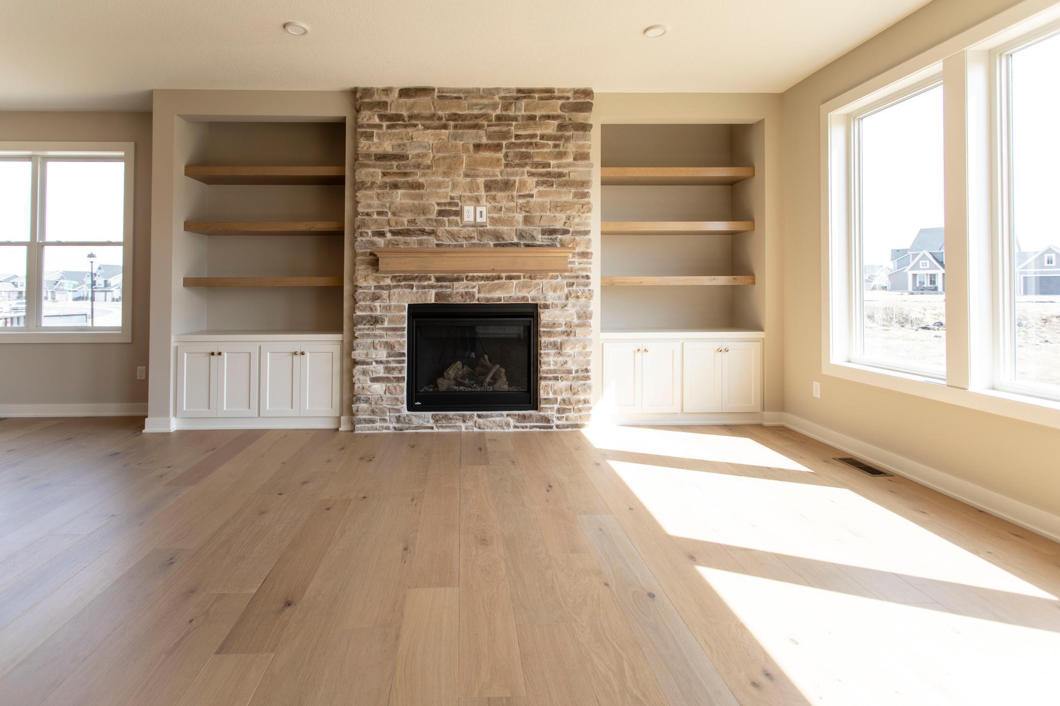 Main floor living room gas fireplace, built-ins and hardwood floors throughout