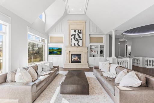 Floor-to-ceiling fireplace serving as a stunning focal point and custom built-ins offering both style and functionality