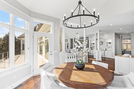 Informal dining area with large windows overlooking the backyard