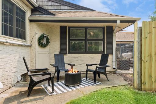 Back patio wraps around to a cozy firepit area.