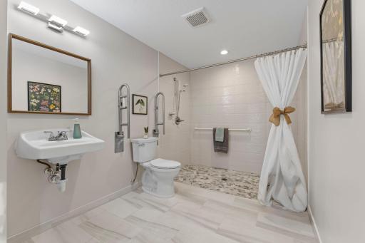 The 3/4 bathroom features a curbless tile shower, offering easy accessibility for everyone!