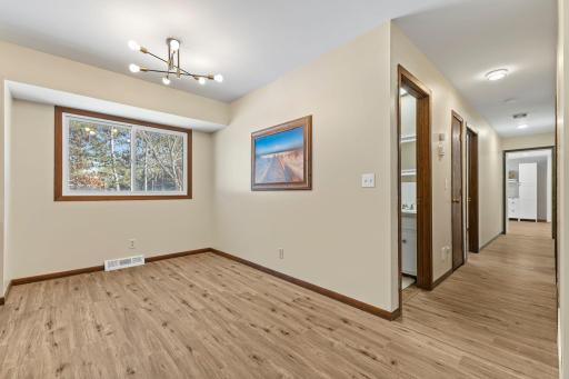 A view down the hallway leading to the four bedrooms and both bathrooms.