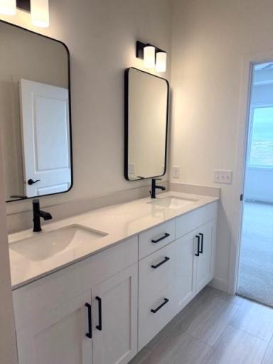 Primary Bath suite with dual sinks walk-in shower and closet