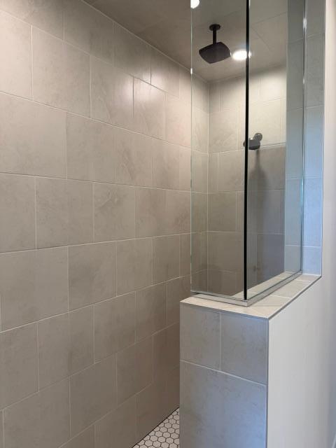 Tiled walk-in shower with rain shower