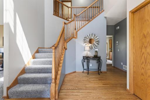 Love the 2 story entry w/wood banister, hard wood floors and coat closet! Left to den, straight to kitchen, right to mud room
